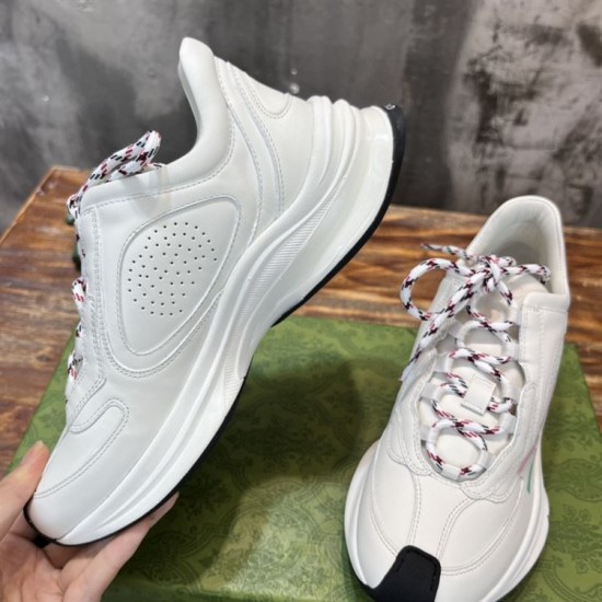 Medial side view of white leather trainer featuring perforated panel