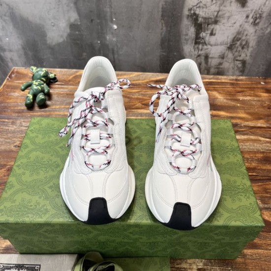 Frontal view of white leather trainers with patterned laces
