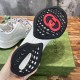 Underside view of black and white rubber outsole with red logo accent