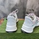 Rear view of white trainers displaying branded black sole overlay