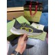 Gucci Run Trainer Lateral View in black and yellow Hand holding lateral profile of Gucci Run black mesh trainer highlighting yellow monogram detail