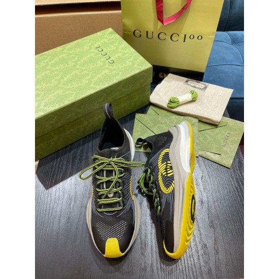 Gucci Run Trainers Front Angle in black and yellow Front oblique angle of black and yellow Gucci Run trainer pair with branded dust bag in background