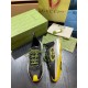 Gucci Run Trainers Front Angle in black and yellow Front oblique angle of black and yellow Gucci Run trainer pair with branded dust bag in background