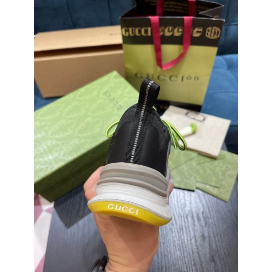 Gucci Run Trainer Heel Detail in black and yellow Rear view of Gucci Run trainer heel counter featuring pull tab and yellow branded rubber panel in black and yellow
