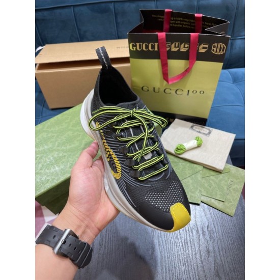 Gucci Run Trainer Upper Detail in black and yellow Close-up hand view of the top and lace unit of Gucci Run trainer in black with yellow accents