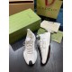 Pair of White Gucci Run Knit Trainers with Packaging Pair of white Gucci Run knit trainers angled on a table next to branded packaging