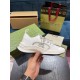 Handheld Side View of White Gucci Run Knit Trainer Hand holding white Gucci Run knit trainer displaying side profile and side logo detailing