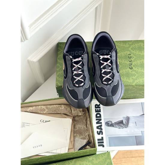 Top-down view of Gucci grey and black trainers showing lace closure