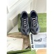 Top-down view of Gucci grey and black trainers showing lace closure
