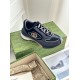 Three-quarter view of single grey and black Gucci trainer on box
