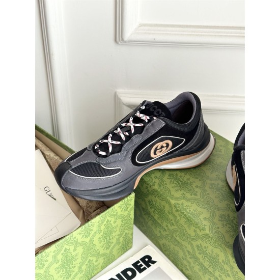 Elevated side view of grey and black Gucci trainer with branded tongue