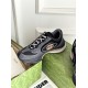 Elevated side view of grey and black Gucci trainer with branded tongue