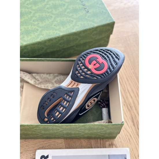 Underside view of grey and black Gucci trainer showing tread sole design