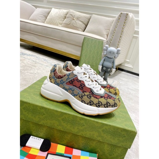 Gucci Rhyton Multicolour Trainers Pair View in multicolour and white Pair of Gucci Rhyton GG Multicolour Trainers sitting on a green shoe box in multicolour and white