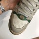 Close-up of perforated toe cap and metal double G hardware on beige Gucci Screener high top trainers in off-white and beige
