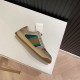 Gucci Screener Trainers Lateral Angle in beige and green Angled lateral view of Gucci Screener trainer resting on white table in beige and green