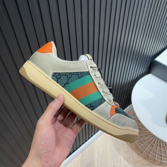 Gucci Screener Trainers GG Canvas Side Detail in beige and green Hand holding Gucci Screener trainer displaying green GG canvas paneling in beige and green