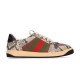Gucci Screener Python Embossed Leather Trainers Side Profile in cream and green Side profile view of Gucci Screener python embossed leather trainers in cream with green and red Web stripe