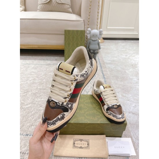 Gucci Screener Python Embossed Leather Trainer Front Perspective in cream and green Hand holding Gucci Screener python embossed trainer demonstrating front profile and metal logo plaque in cream and green