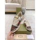 Gucci Screener Python Embossed Leather Trainer Front Perspective in cream and green Hand holding Gucci Screener python embossed trainer demonstrating front profile and metal logo plaque in cream and green