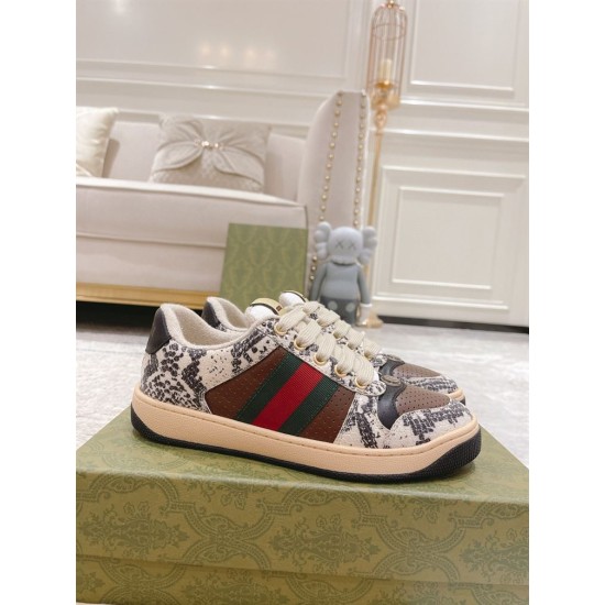 Gucci Screener Python Embossed Leather Trainers Pair View in cream and green Pair of Gucci Screener python embossed leather trainers sitting on branded shoebox in cream and green