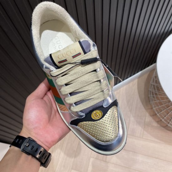 Gucci Screener Metallic Silver Gold Web Stripe Leather Trainers Tongue Detail Close-up of tongue label and oval GG hardware on Gucci Screener Trainers in silver and gold