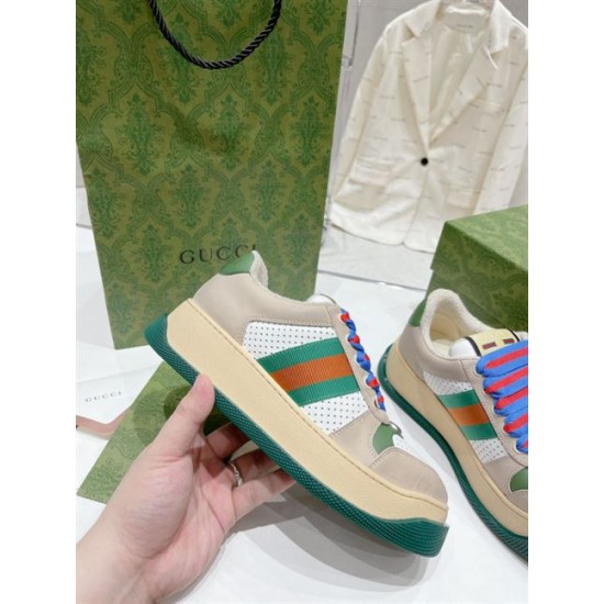 Gucci Screener Trainer Handheld View in beige and green Hand holding single Gucci Screener trainer highlighting beige midsole and green web stripe