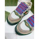 Gucci Screener Trainer Toe Box Detail in beige and green Close-up of Gucci Screener trainer toe box with oval GG logo plaque in beige and green