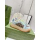 Pair of light blue Gucci Screener platform trainers resting on a green shoe box in light blue and beige