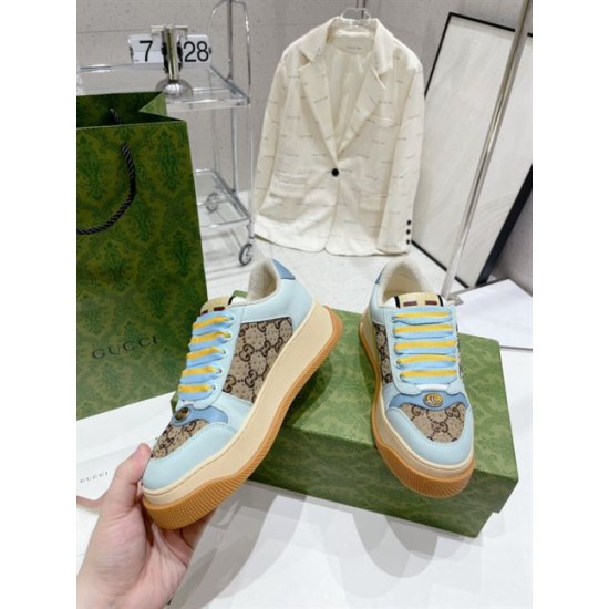 Hand holding a light blue Gucci Screener platform trainer displaying front and side profile in light blue and beige