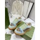 Angled front perspective of both light blue Gucci Screener platform trainers in light blue and beige