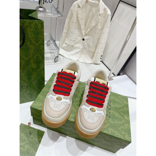Beige Gucci Screener GG Lurex Platform Trainers Pair View Pair of beige Gucci Screener GG lurex platform trainers resting on green shoe box