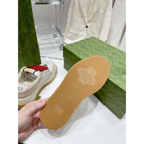 Gucci Screener Trainer Rubber Sole and Bee Emblem View in beige Underneath view of tan rubber sole with textured tread pattern and bee emblem on Gucci trainer in beige