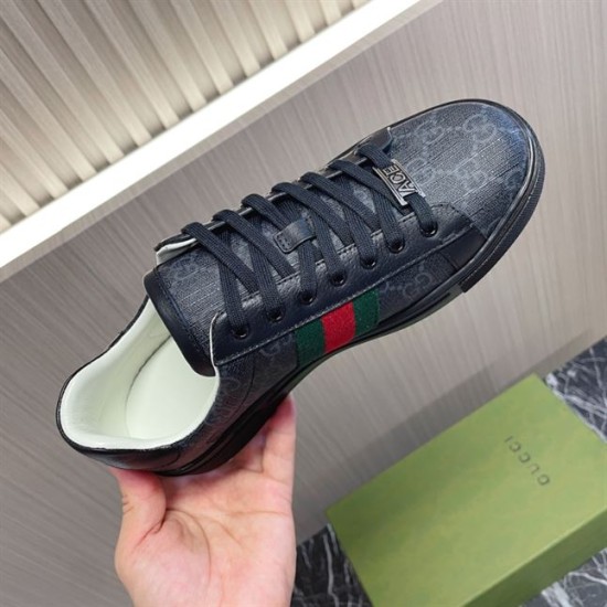 Gucci Black Monogram Web Trainer - Close Up in black and white Hand holding a Gucci black monogram web trainer showing side profile and collar lining in black and white