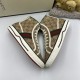 Pair of Gucci Tennis 1977 beige high top trainers angled showing sole edge embossed logo detail in beige and green