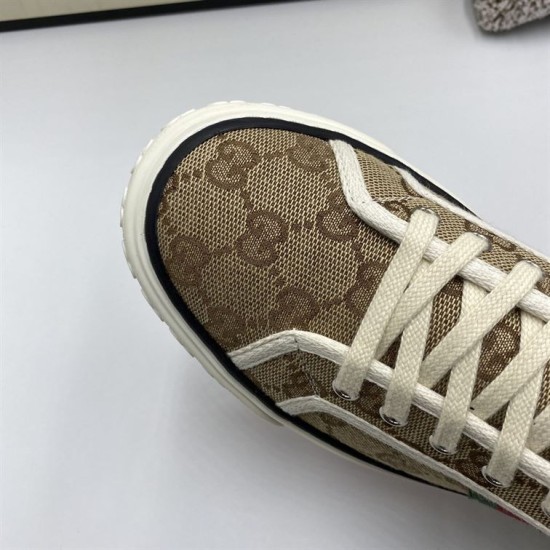 Macro detail view of the toe cap pattern and lace eyelets on beige GG canvas high top trainers in beige and green