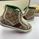 Close-up side view showing embroidered 77 logo and off-white piping on beige monogram trainers in beige and green