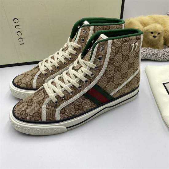 Three-quarter view of a pair of beige Gucci Tennis 1977 Monogram High Top Trainers with off-white laces in beige and green