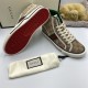 Red patterned rubber outsole and profile view of Gucci Tennis 1977 beige monogram high top trainers in beige and green