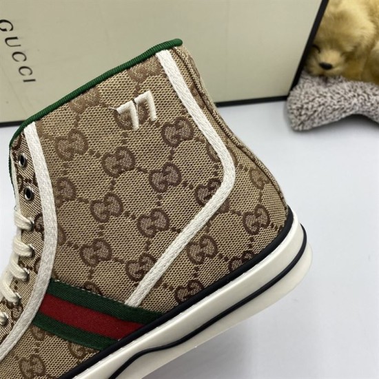 Close-up showing embroidered 77 motif and green padded collar on Gucci beige high top trainers