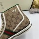 Close-up showing embroidered 77 motif and green padded collar on Gucci beige high top trainers
