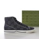 Gucci Grey High-Top Trainer Studio View Side view of Gucci grey GG canvas high-top trainer beside green shoe box