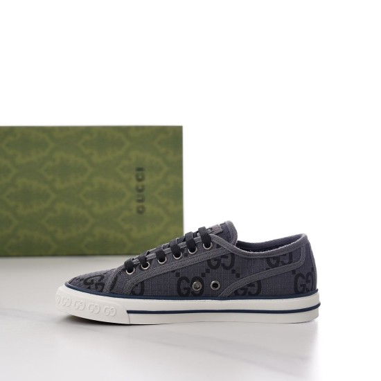 Medial side view of grey Gucci Tennis 1977 monogram trainer showing side ventilation eyelets