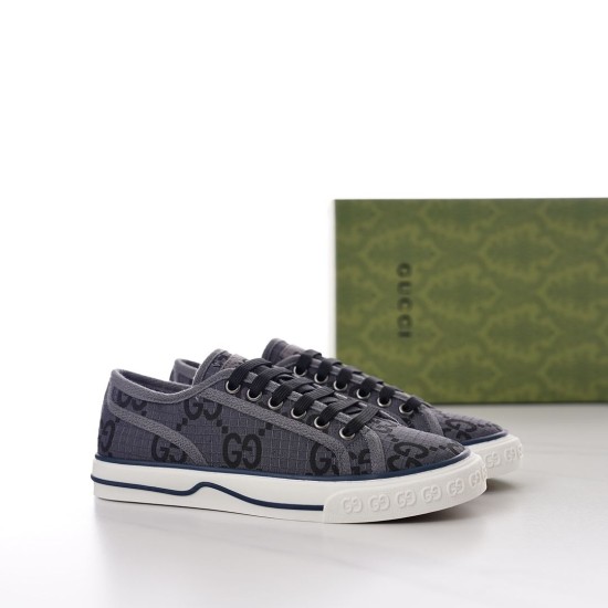 Pair of grey monogram Gucci Tennis 1977 low top trainers angled view