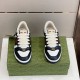 Front view of both Gucci Screener black and white trainers showcasing lace system and oval Double G plaque