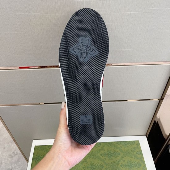 Bottom outsole view of Gucci Screener trainer showing black textured tread and bee motif in black and white