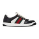 Side profile view of Gucci Screener black and white low top trainer showing green and red Web stripe