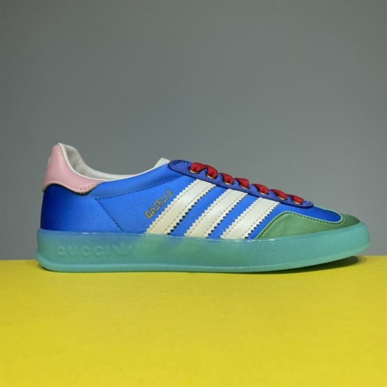 Gucci x Adidas Gazelle Trainer Lateral Profile in blue and white Profile shot of the blue satin Gucci x Adidas Gazelle trainer showing the translucent turquoise sole in blue and white