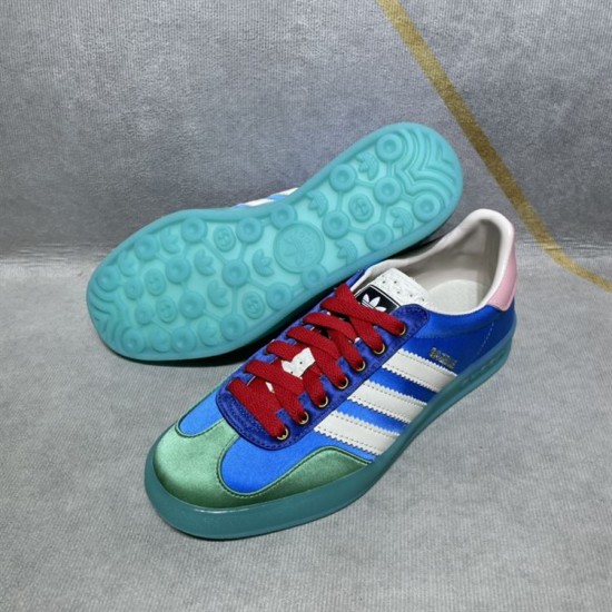 Gucci x Adidas Gazelle Sole Tread in blue and white Underside view of the turquoise semi-translucent patterned rubber sole alongside a blue trainer in blue and white