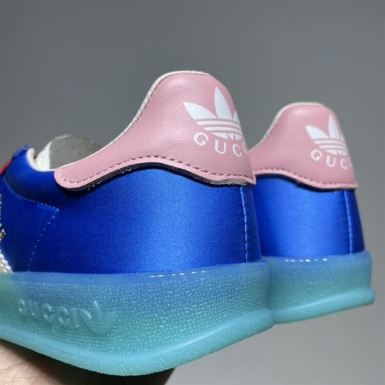 Gucci x Adidas Gazelle Heel Tab Detail in blue and white Close-up of the pink heel tabs on the blue Gucci x Adidas Gazelle trainers displaying white brand logos